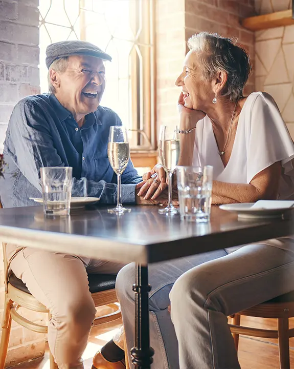 happy senior couple at restaurant attending one of our seminars